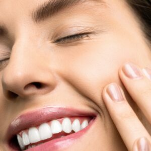 Close-up Photo of Woman With Pink Lipstick Smiling with Her Eyes Closed